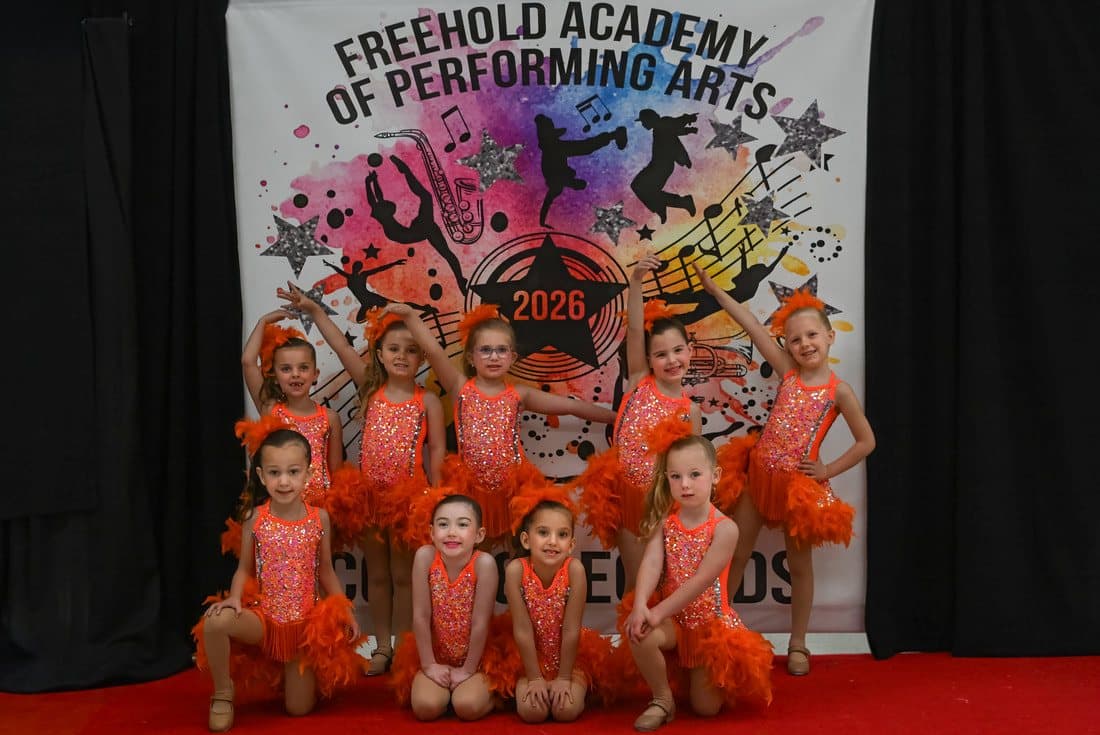 Young dancers in orange costumes